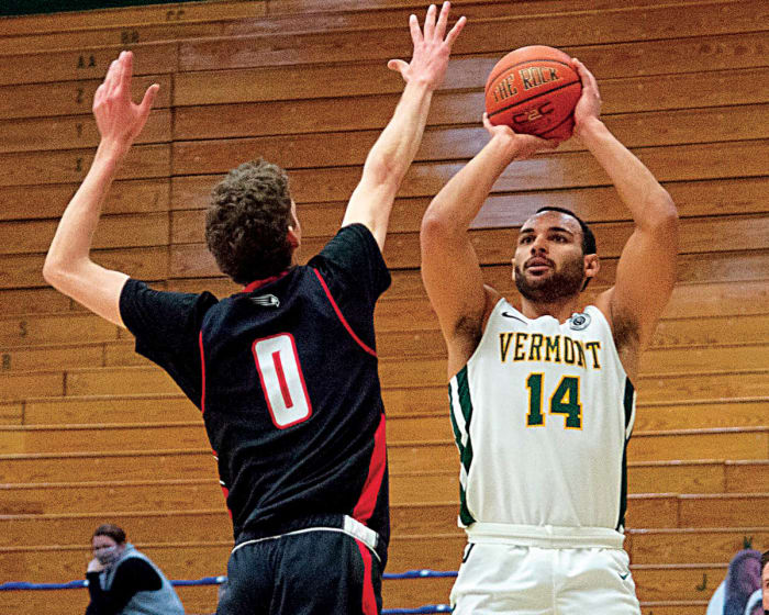 Vermont's Isaiah Powell (14) shoots a three pointer during the America East semi final basketball game between the Hartford Hawks and the Vermont Catamounts at Patrick Gym last season.
